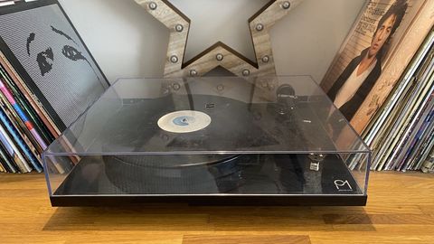 Rega Planar 1 turntable flanged by two stacked of records