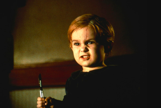 Miko Hughes as the little brother holding a knife in 'Pet Sematary'