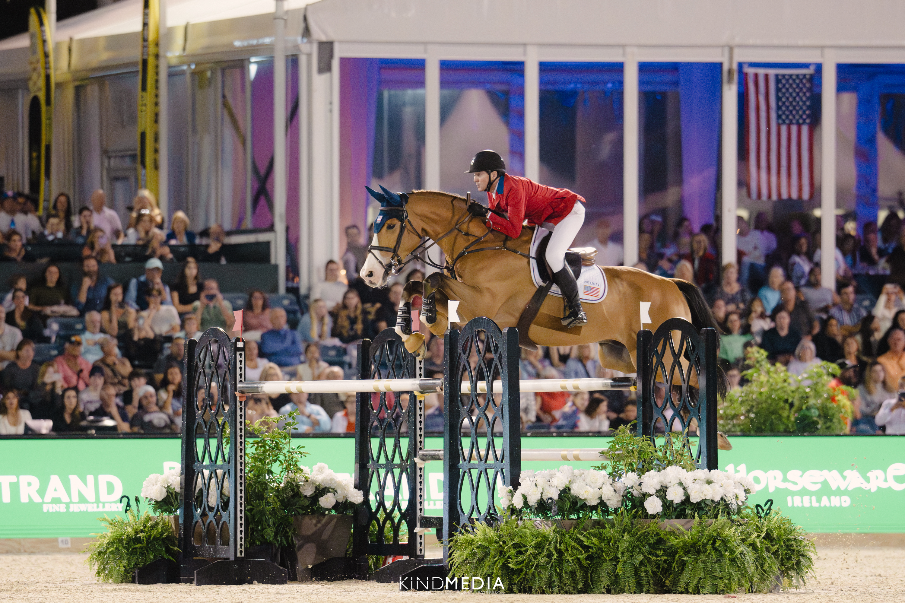 A horse leaps over a gate in an equestrian competition.