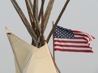 American flag next to teepee