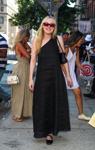 Dakota Fanning wears a one shoulder linen dress from dishh in new york city