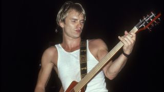 Photo of POLICE and STING, Sting performing live onstage, playing Hamer 8 string bass