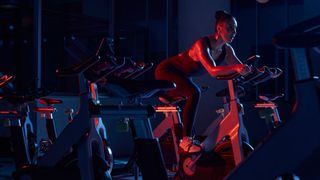 Woman on spinning bike in a studio