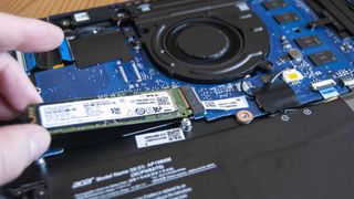 Pull the SSD away from the slot