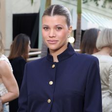 Sofia Richie wearing a navy coat, jeans, and black pumps and Vogue World in Hollywood