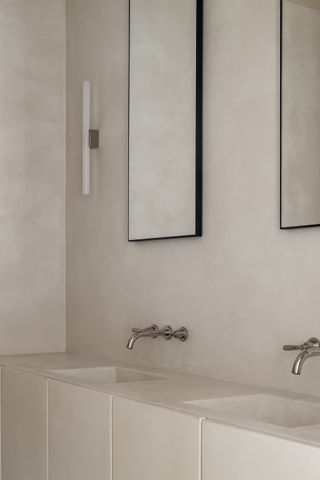 A bathroom with polished nickle faucets