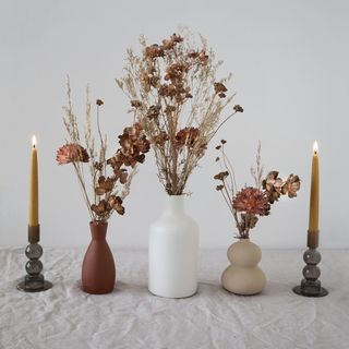 faux flower vase with candle stands