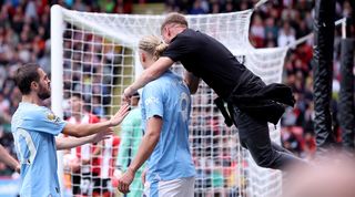 Manchester City's Erling Haaland is jumped on by a fan after heading his side into the lead at Sheffield United in the Premier League in August 2023.