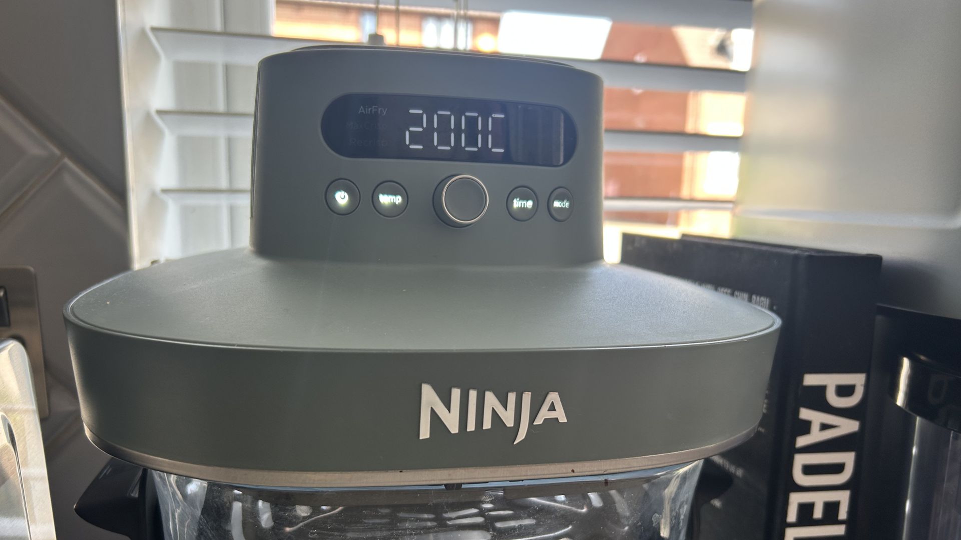 Ninja Crispi air fryer close up with screen on