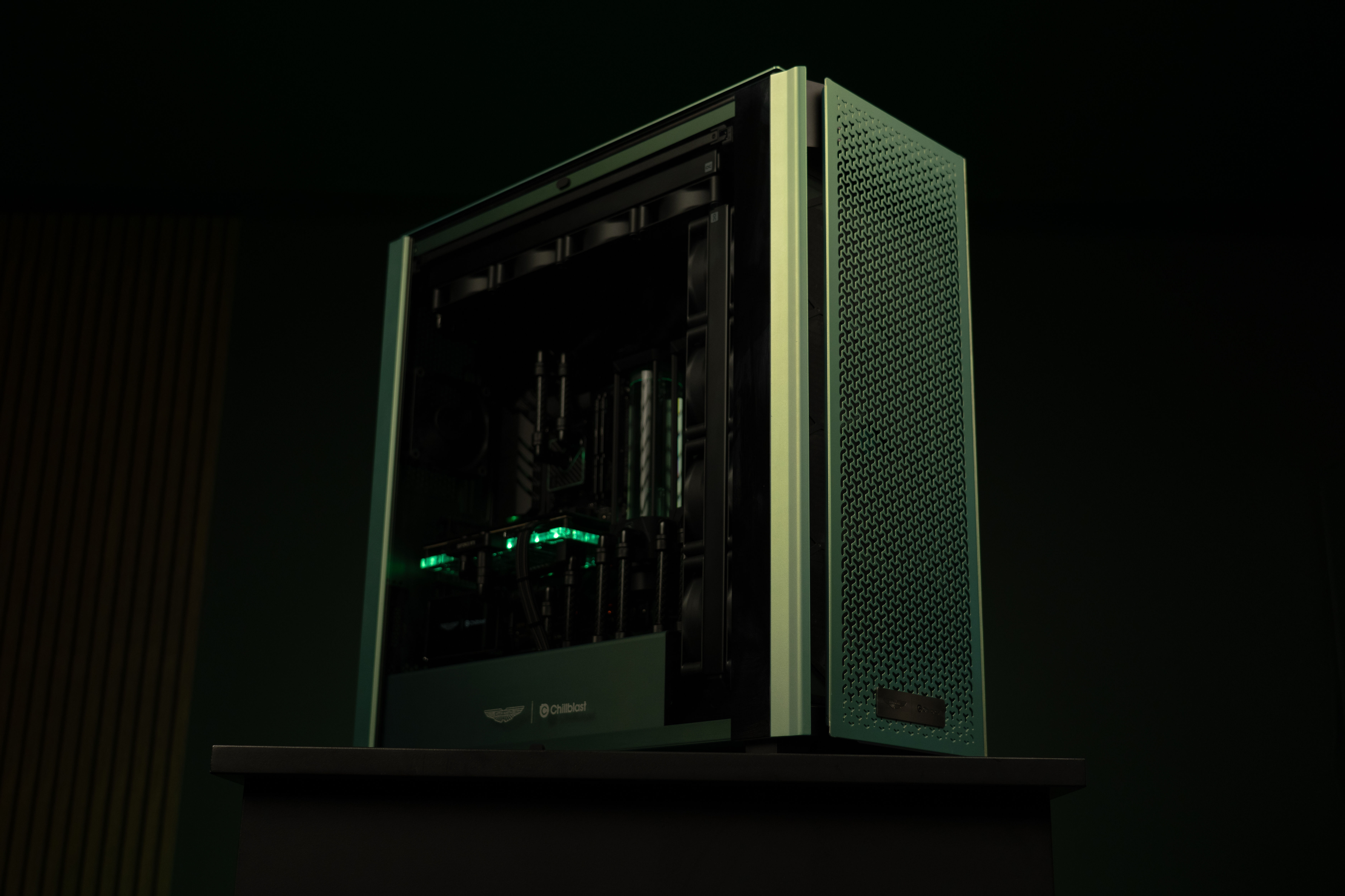 A PC gaming rig designed by Aston Martin, green with wood pannelling