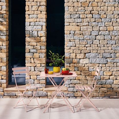 bistro set having stone wall background