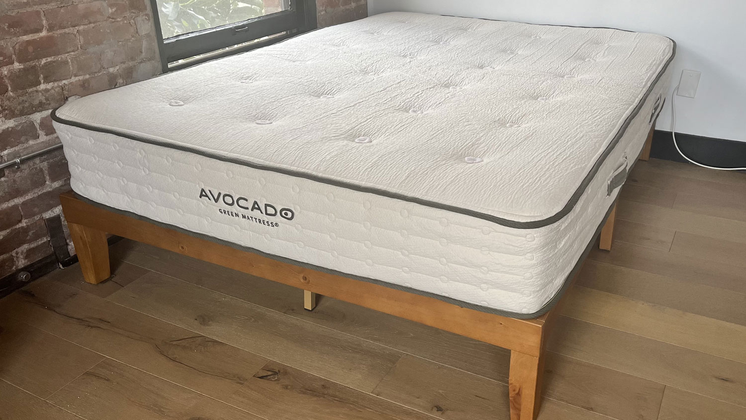 The Avocado Green mattress on a bed