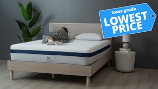 Sleep editor lying on the Helix Midnight mattress, with a 'Lowest price' flag overlaid