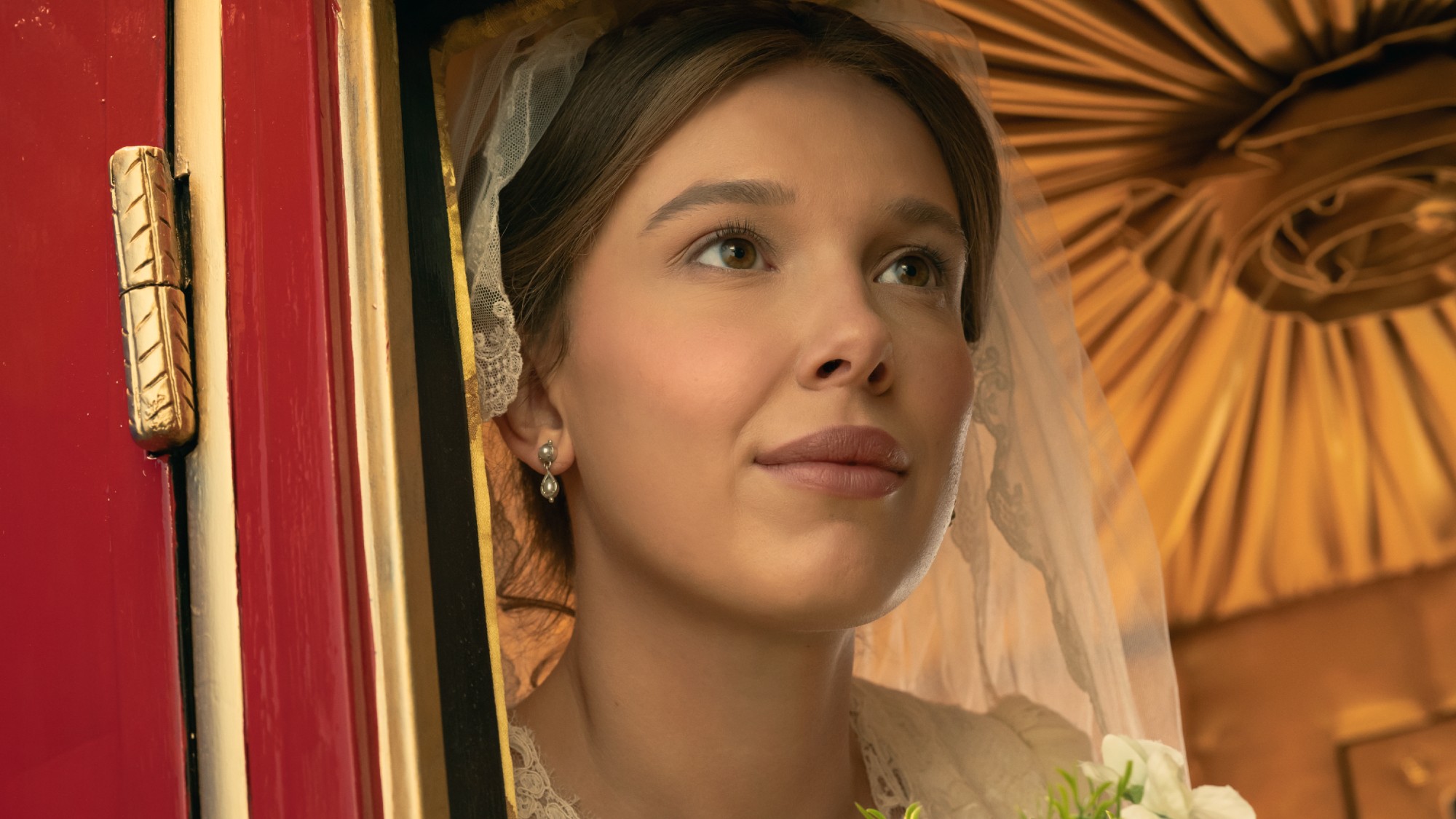 Millie Bobby Brown in a wedding dress in Enola Holmes 3. 