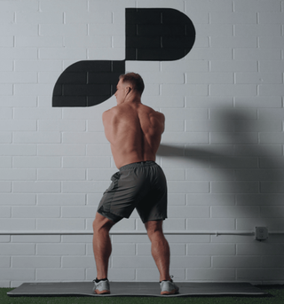 Noah Ohlsen performing the wall isometric rotation hold stretch