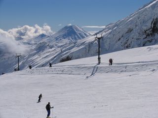 Skiers on a bright and sunny day at Whakapapa in New Zealand