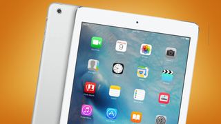 A first-gen Apple iPad on an orange background