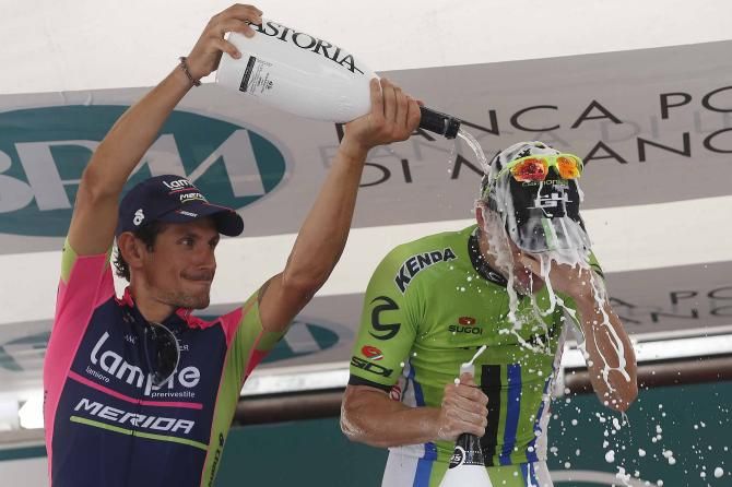 Filippo Pozzato douses Elia Viviani in champagne after the Coppa Bernocchi.
