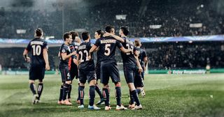 Marquinhos of Paris Saint-Germain #5 celebrates with team mates as he scores their first goal during the UEFA Champions League Round of 16 second leg match between Paris Saint-Germain FC and Bayer Leverkusen at Parc des Princes on March 12, 2014 in Paris, France.