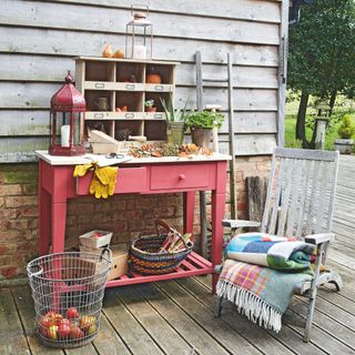 shelves on pink table drawer and chair fruit basket on wooden flooring