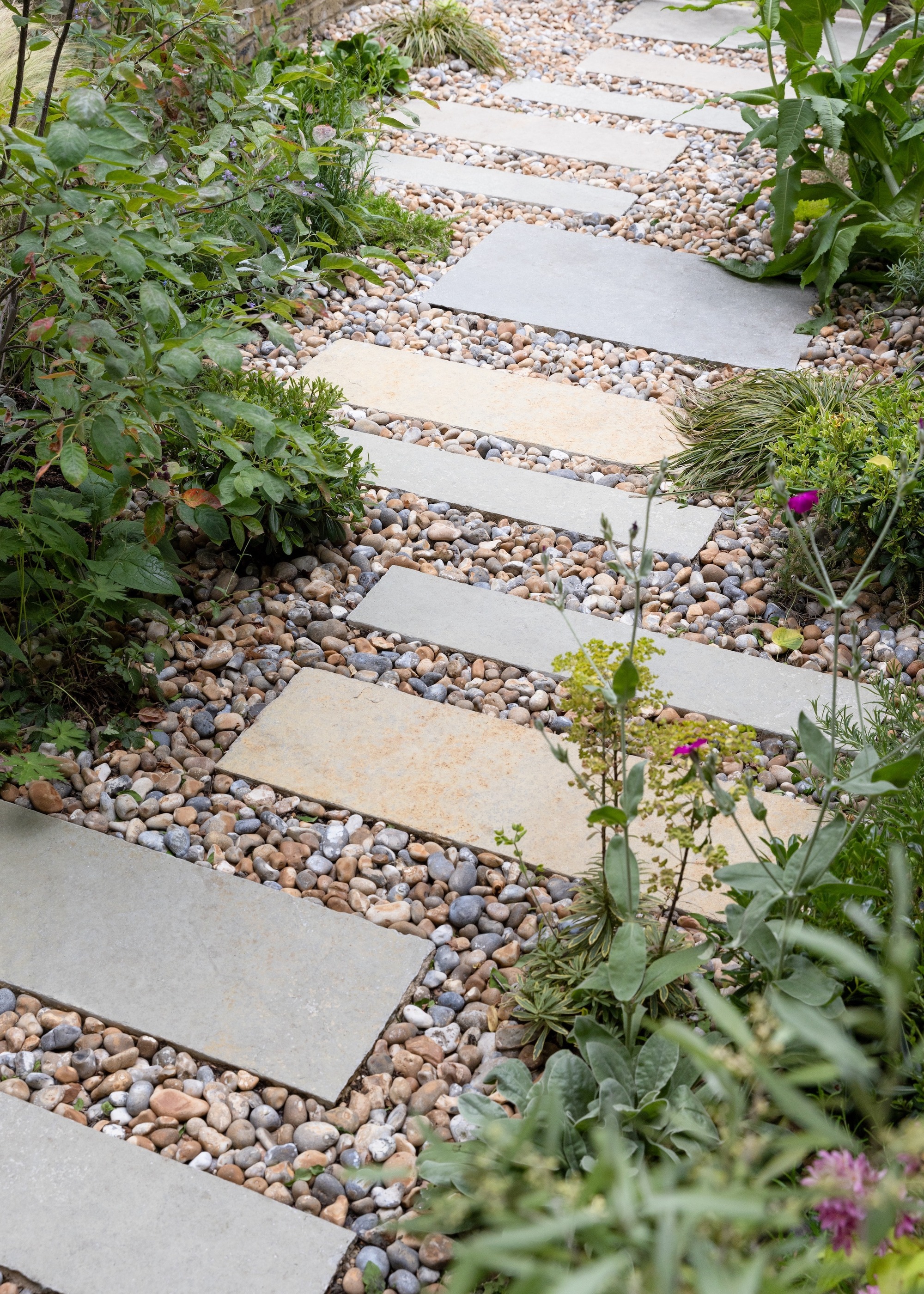 Garden path made with staggered slabs and pebbles