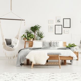 white room with swing and potted plants