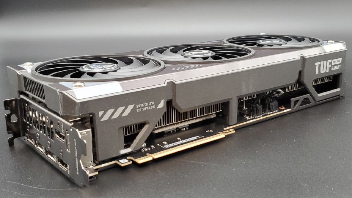 The Asus TUF Gaming RTX 5070 Ti OC Edition on its side, on a silver background