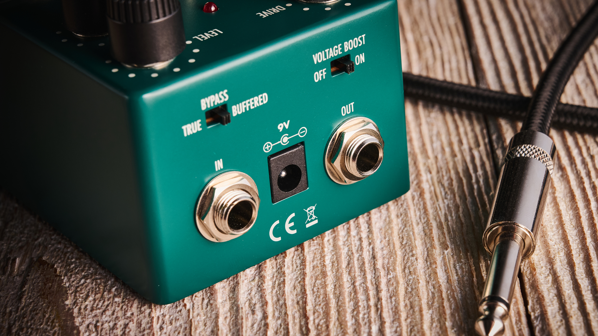 Warm Audio Tube Squealer green overdrive pedal shot on wood floorboards