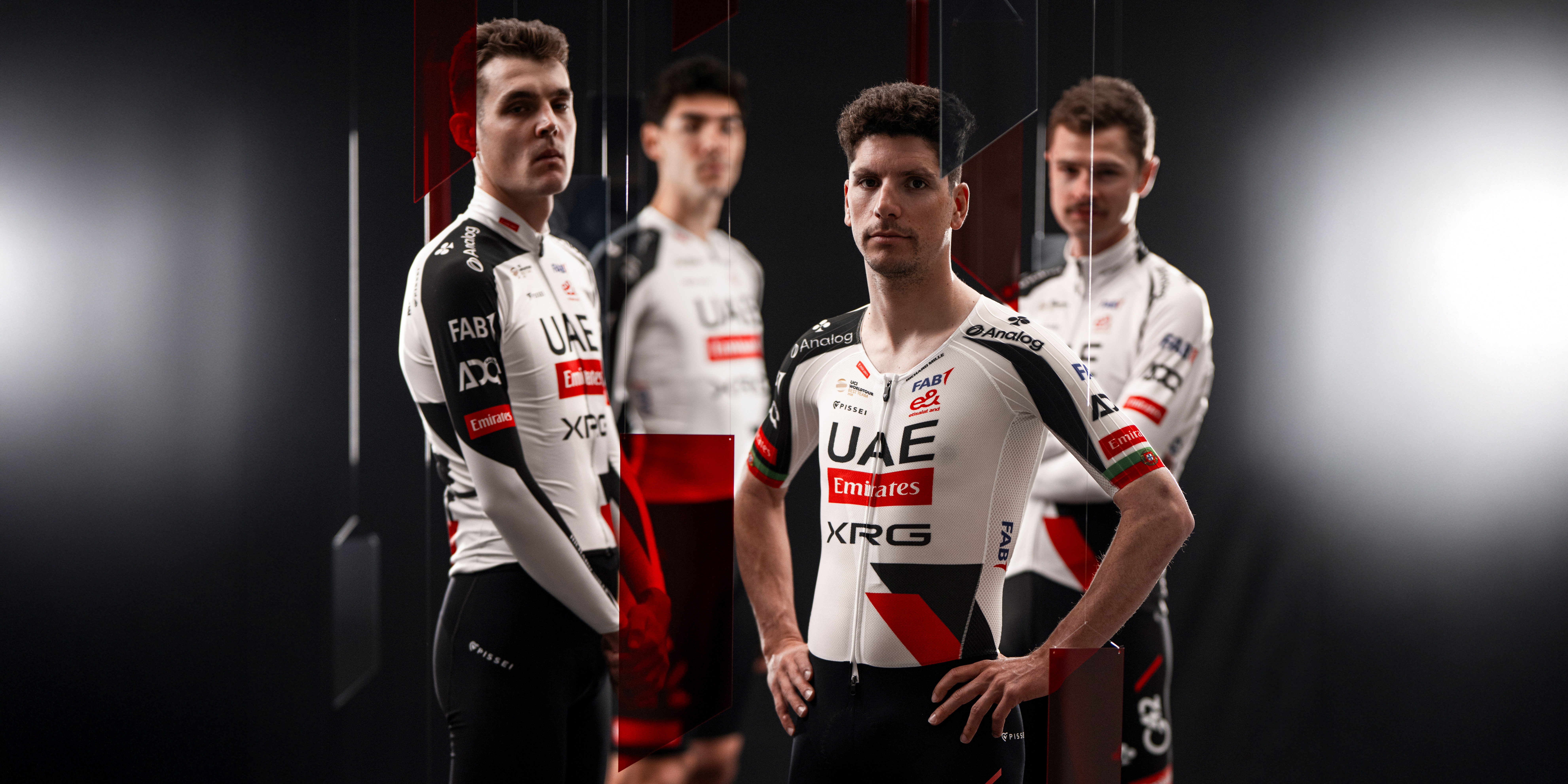 Four male riders in UAE Team Emirates-XRG kit