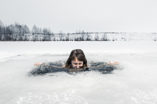 a person in an icy pond to illustrate the best cold plunge tubs of 2024