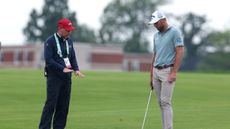 Sam Burns speaks to a rules official at the US Open