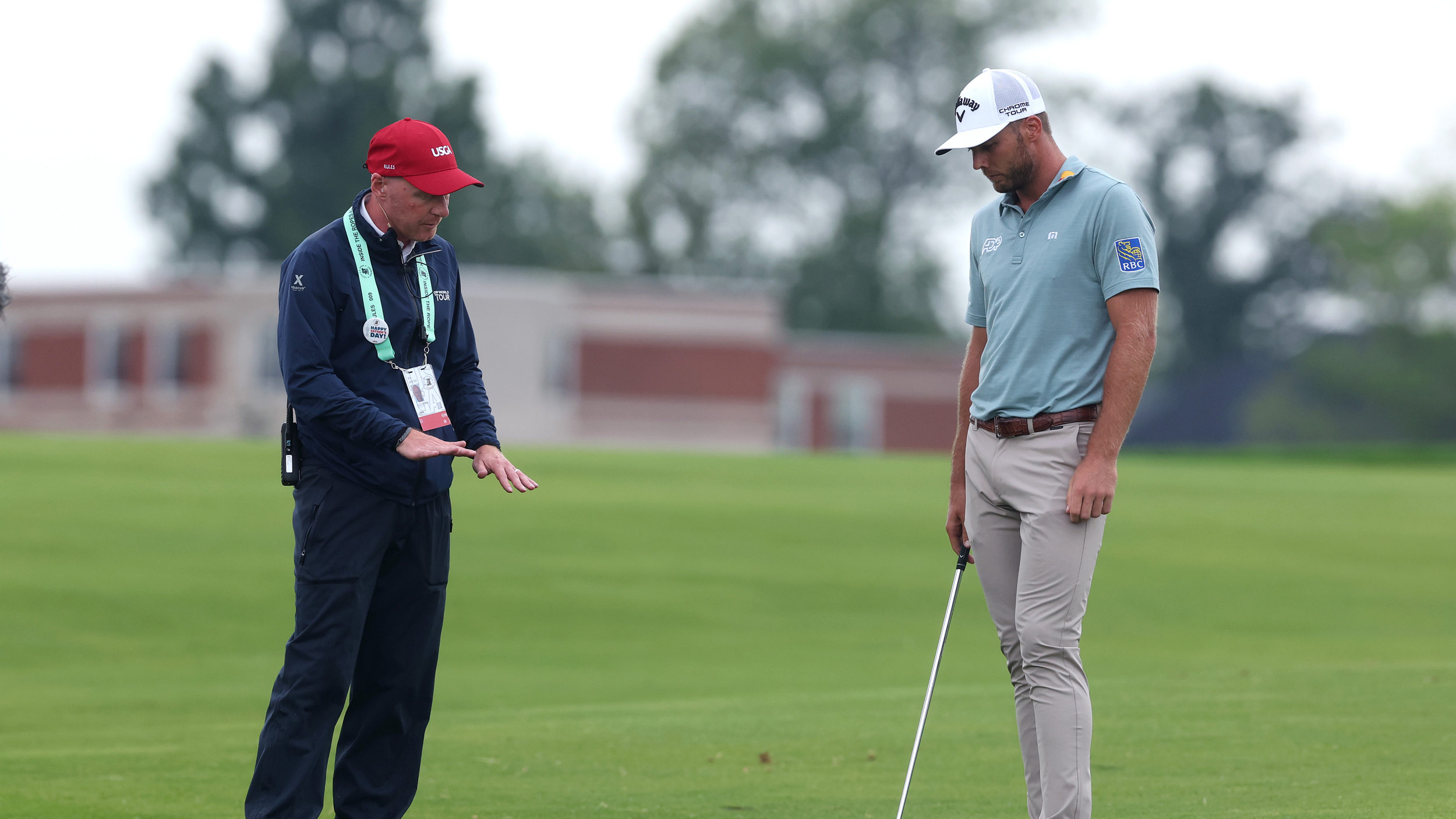 Sam Burns speaks to a rules official at the US Open