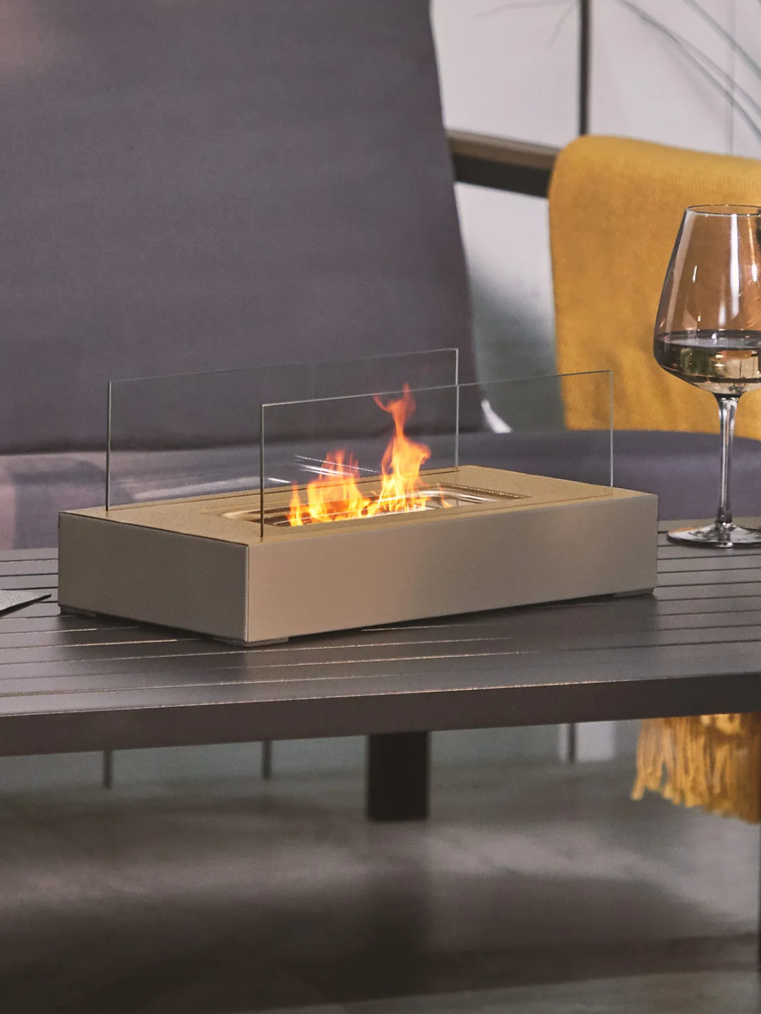 A beige fire pit table topper