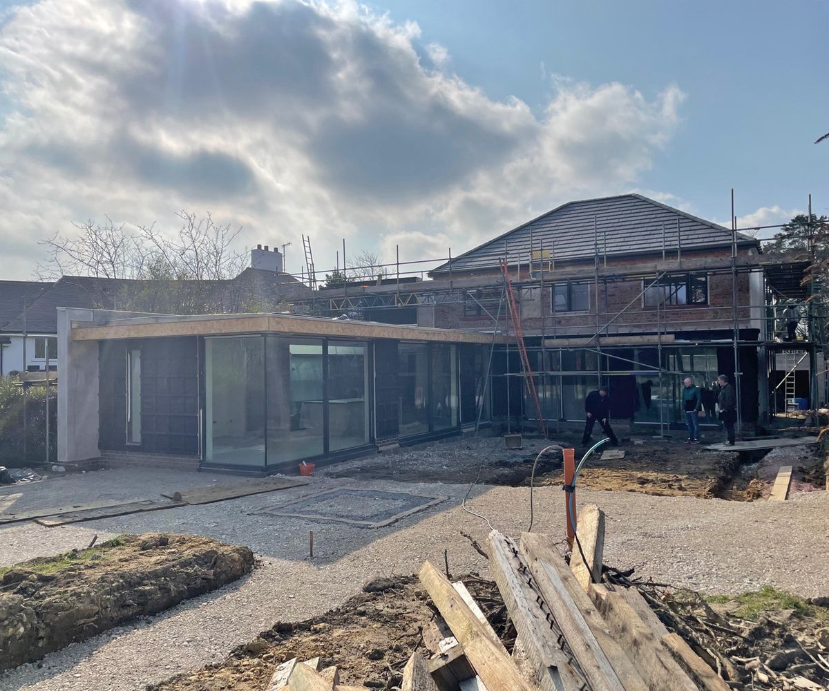 A 1970s detached home during a renovation with a contemporary glass extension
