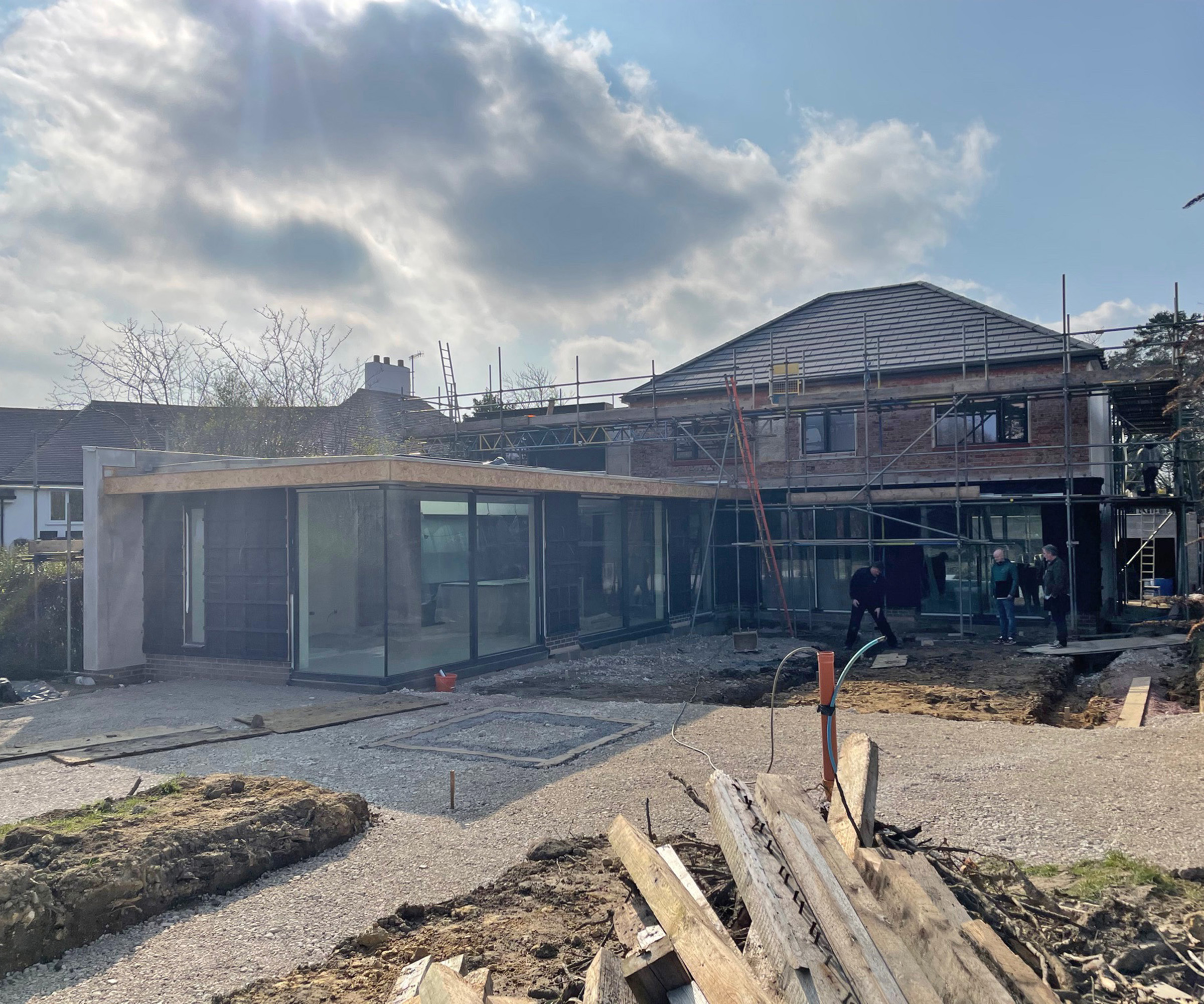 A 1970s detached home during a renovation with a contemporary glass extension