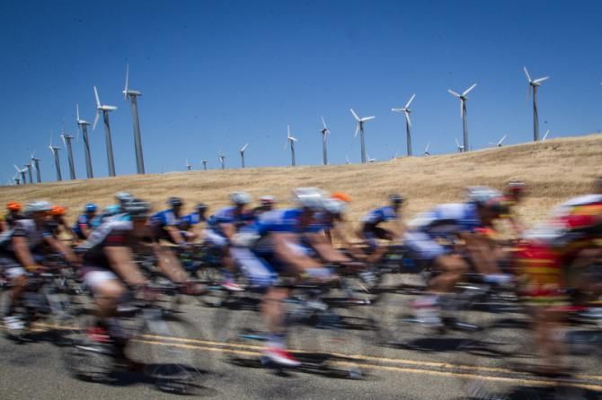 The peloton passes by a wind farm along today's route.