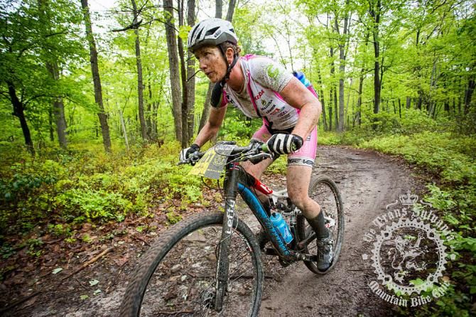 Sue Haywood motoring through the wooded doubletrack.