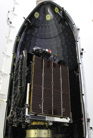 The AsiaSat 6 telecommunications satellite is packed inside a SpaceX Falcon 9 rocket nosecone fairing ahead of its Sept. 7, 2014 launch.