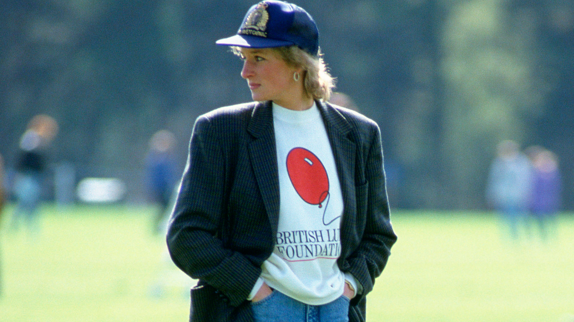 Princess Diana wearing a British Lung Foundation sweatshirt and blazer with a baseball hat