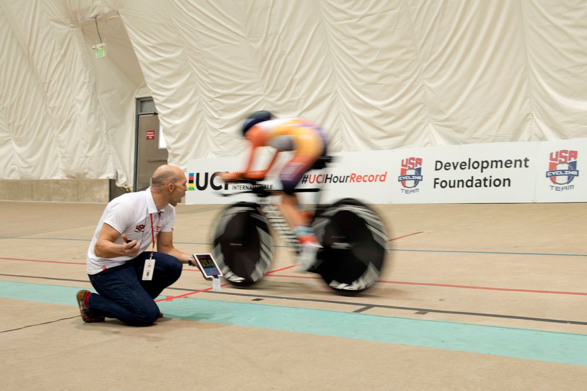 Evelyn Stevens is fed information from her coach during the ride