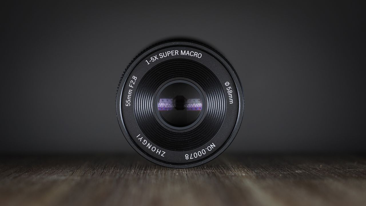 Mitakon 55mm f/2.8 1-5x Macro on a wooden surface