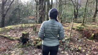 Rear view of a hiker wearing the Helly Hansen Verglas 2.0 down jacket