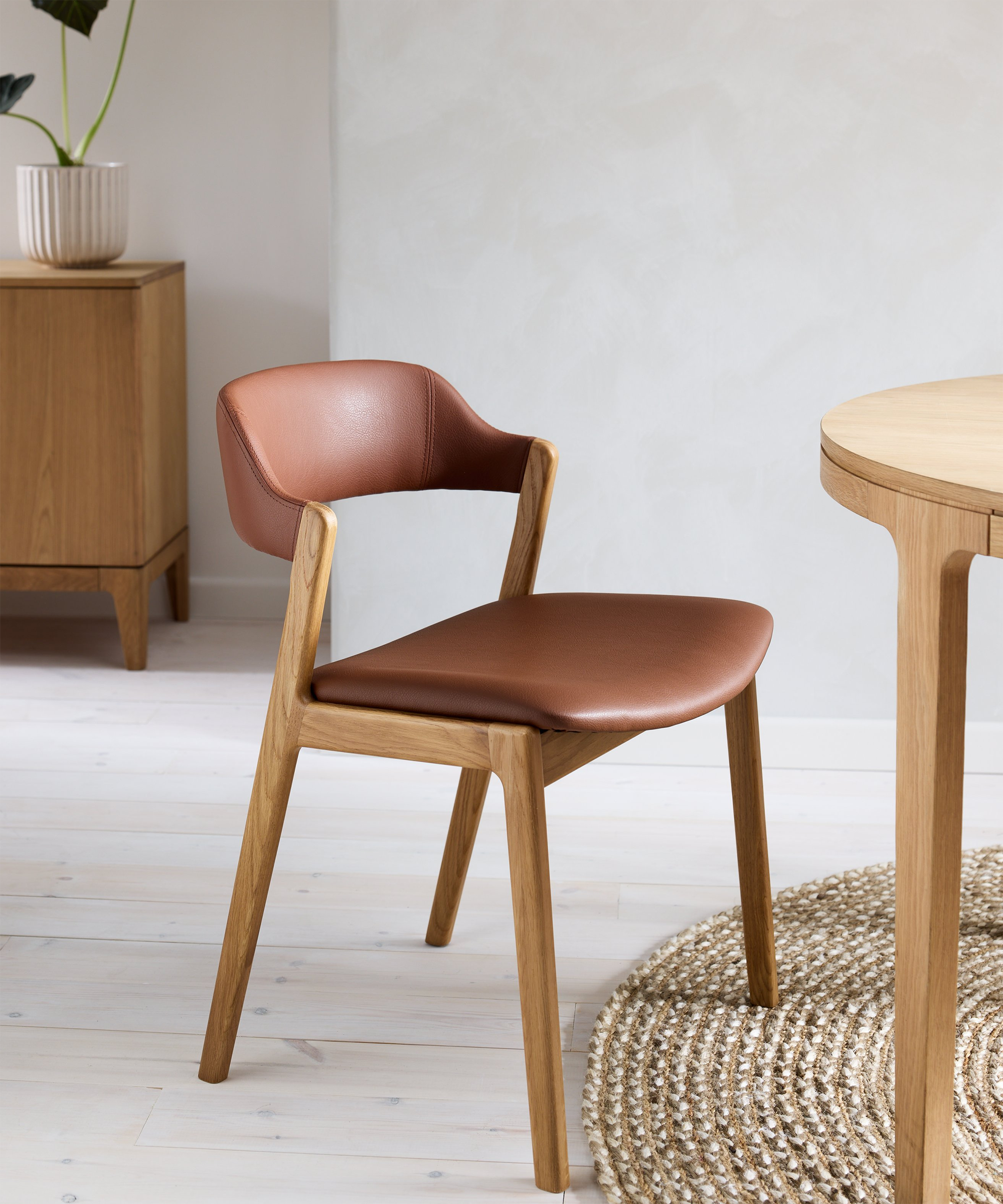 leather dining chair next to a wood table