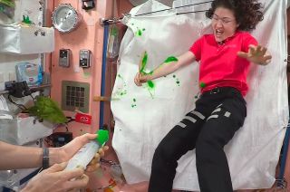 European Space Agency (ESA) astronaut Luca Parmitano sprays NASA astronaut Christina Koch with Nickelodeon's green slime on board the International Space Station.