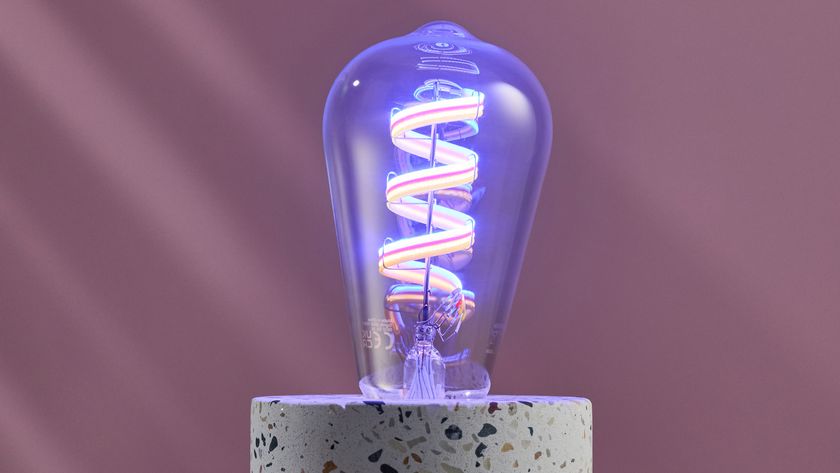 The WiZ filament bulb is lit up blue, with the different colored LEDs clearly visible.