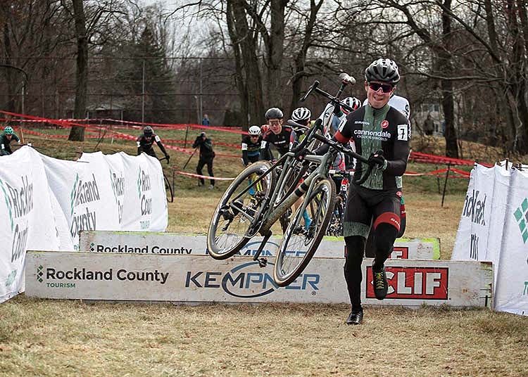 Lane Maher (Cannondale p/b Cyclocrossworld) leads the men through the barriers