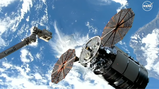 A screenshot shows the Cygnus docking at the ISS on Thurs morning (Feb. 10 with the station's robot arm in view