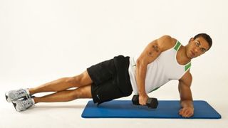 Man performs side plank with dumbbell raise