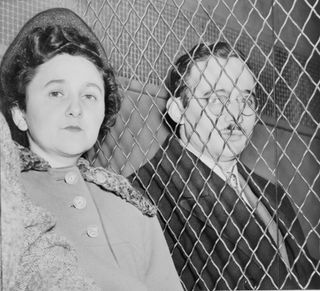 Julius and Ethel Rosenberg, separated by heavy wire screen as they leave U.S. Court House after being found guilty by jury.