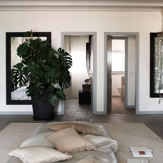 hallway with white wall and cushions and rug